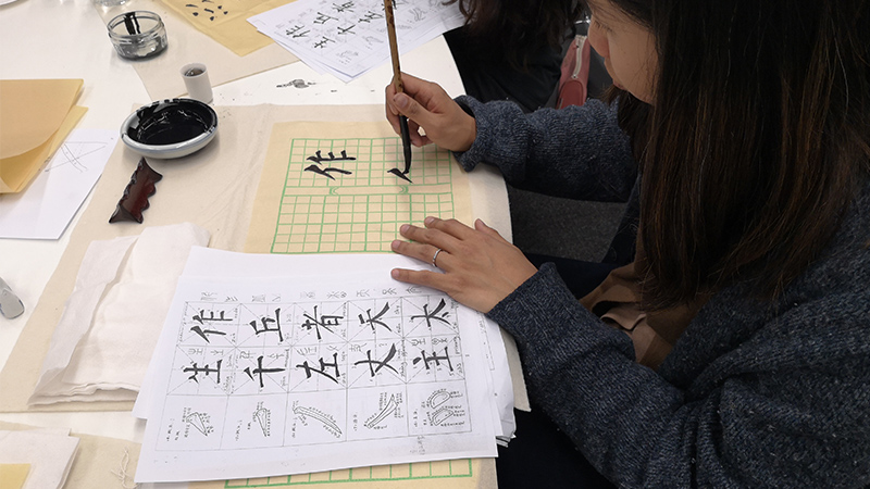 Student writing calligraphy